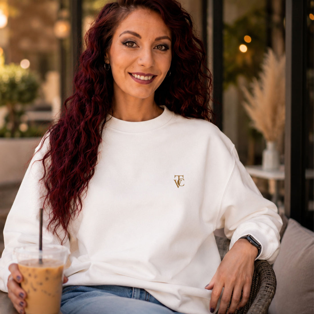 Woman wearing a white minimalist crewneck sweatshirt by Viral Threads Co